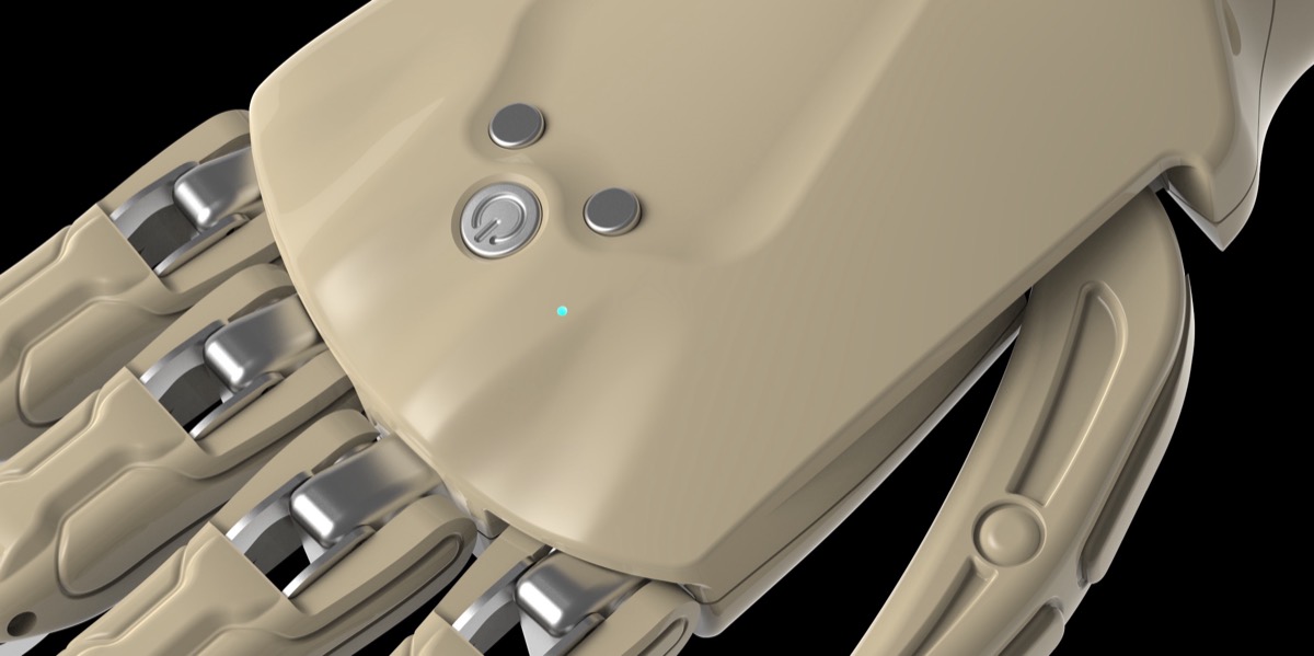 Close view of the back of the hand, showing the two control buttons, the power button, and the indicator light.